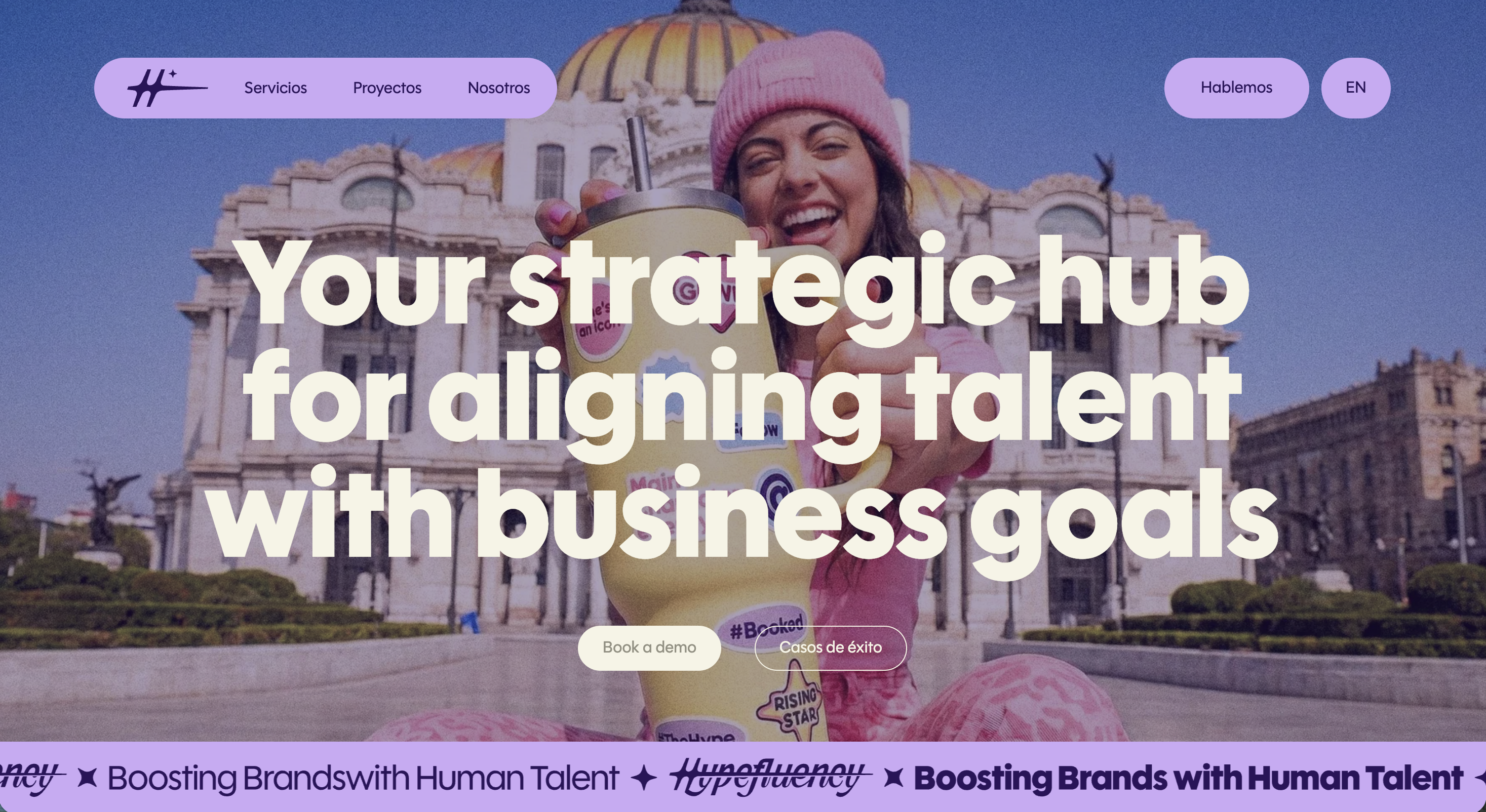 Hypefluency's marketing site with a vibrant photo of a woman in a pink beanie, bold typography reading "Your strategic hub for aligning talent with business goals," and a scrolling ticker of the company tagline